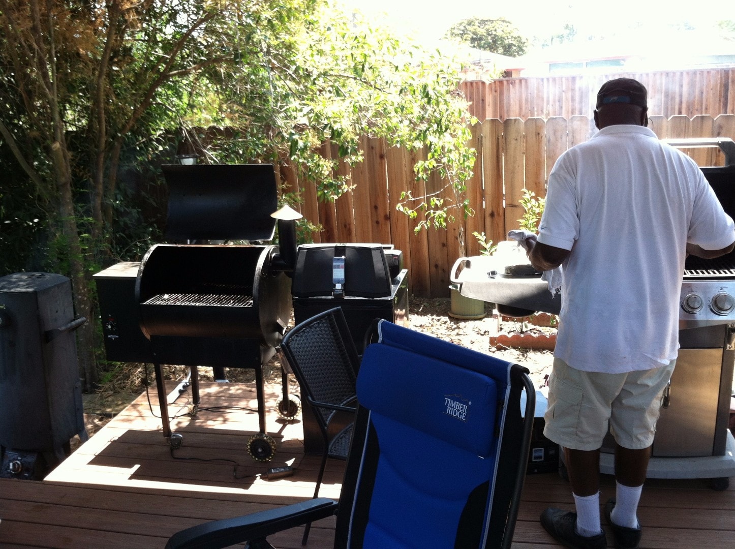 Dr. Charlie Whitcomb behind the barbecue grill in the backyard